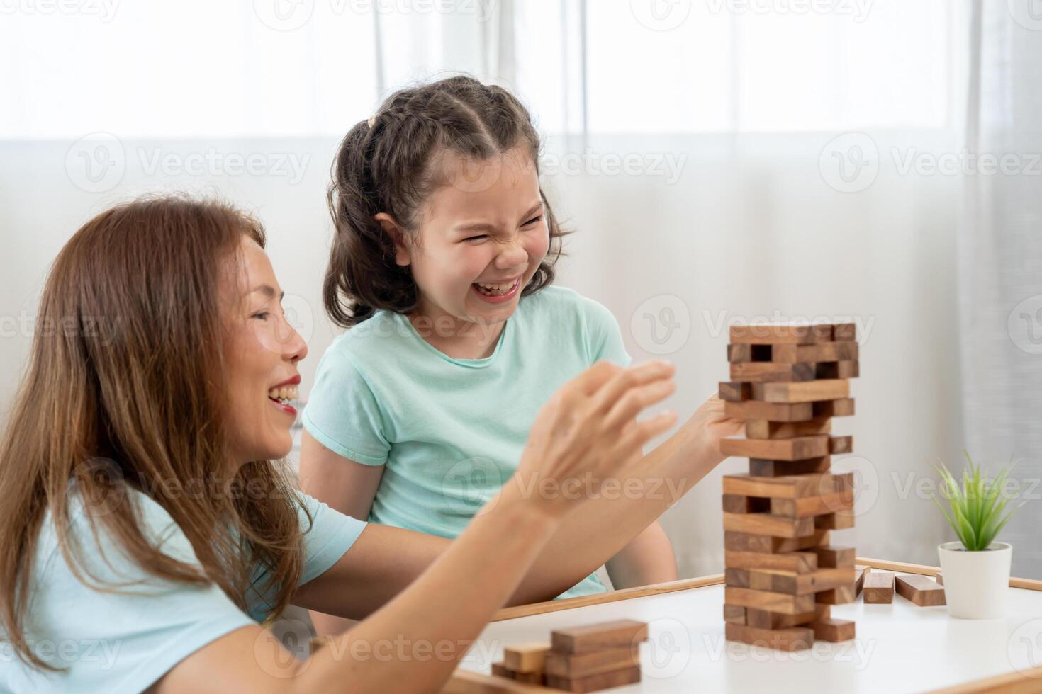 Asia Happy mother playing learning games jan-ga with the little girl. Funny family is happy and excited in the house. mother and son having fun spending time together. holiday, weekend, vacant. photo