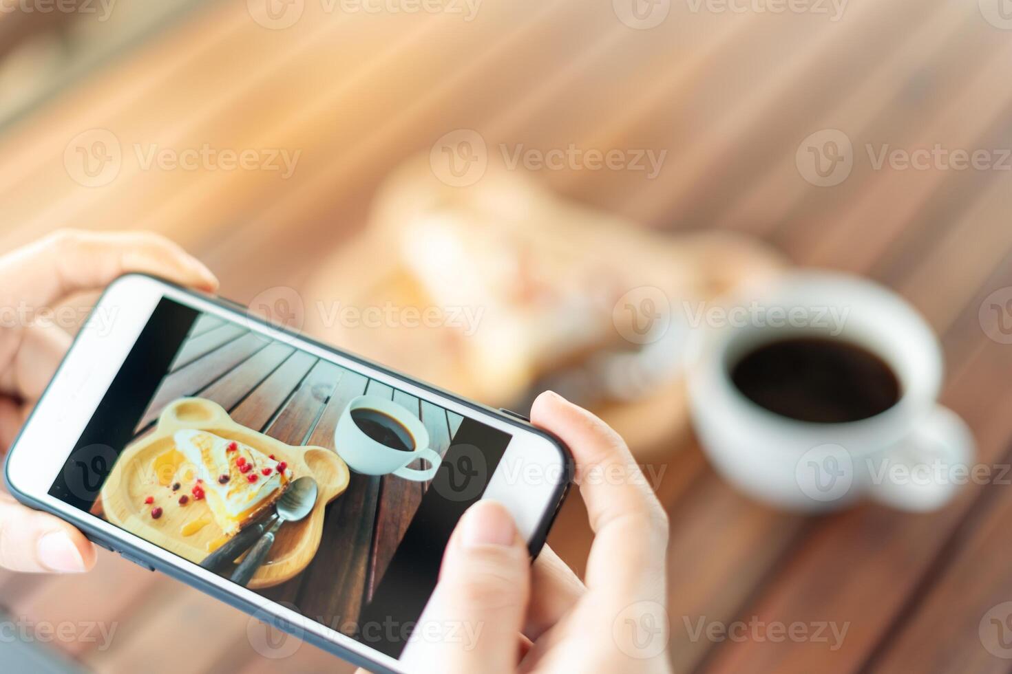 restaurant owner takes a picture of the food on the table with a smartphone to post on a website. Online food delivery, ordering service, influencer, review, social media, share, marketing, interest. photo