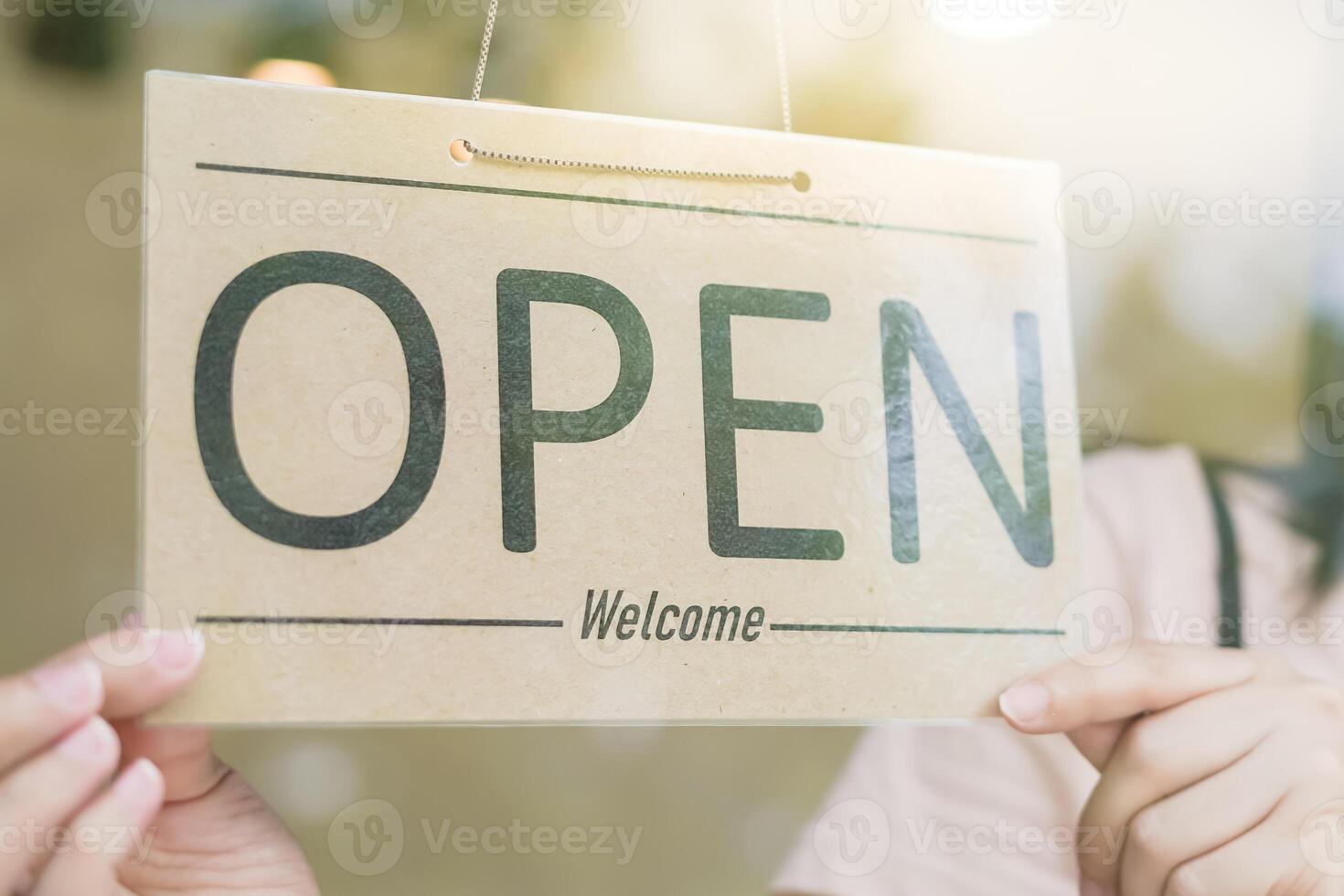 Business woman owner open on the first day of business. guarantees safety, cleanliness, open the coffee shop. open for New normal. Small business, welcome, restaurant, home made photo