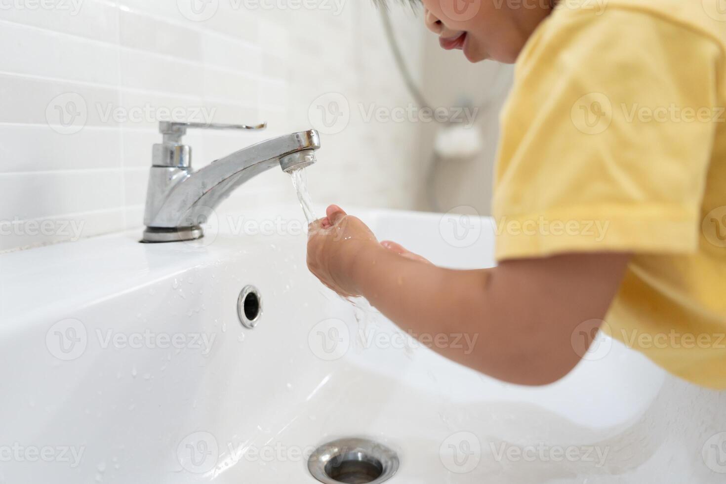 little kid hands wash with soap bubbles and rinse with clean water to prevent and stop the spread of germs after back to home, virus or covid19. Good health and good personal hygiene, virus, bacteria photo