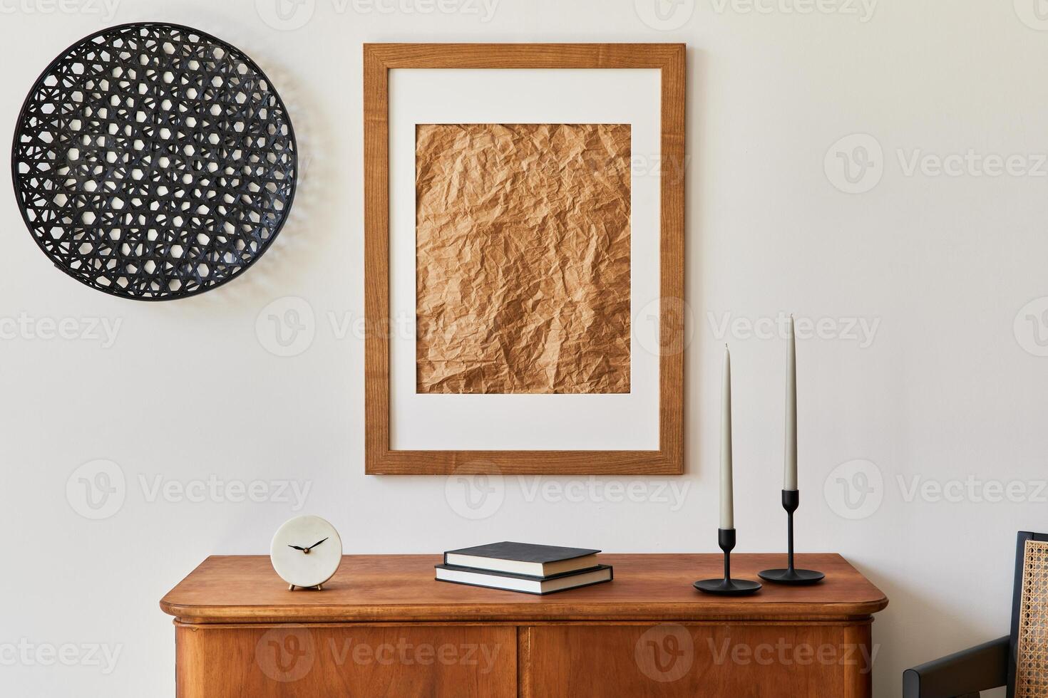 Minimalist composition of living room with brown picture frame, retro commode, decoration and elegant personal accessories in stylish home decor. Template. photo