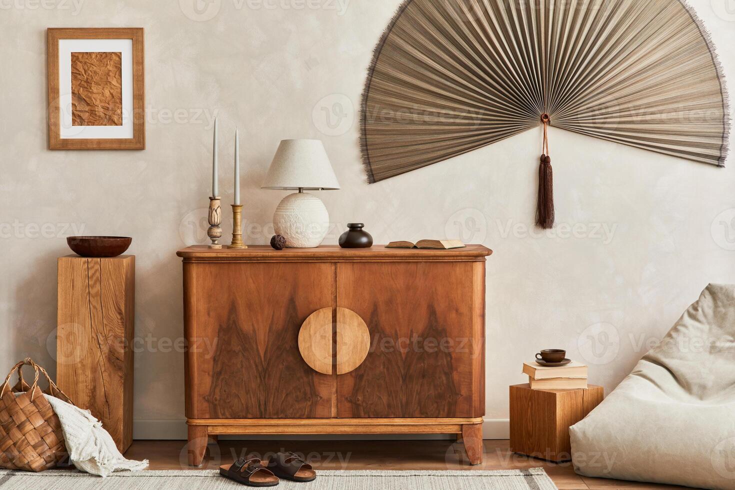 Interior design of living room with stylish retro commode, mock up poster frame, cube, table lamp, decoration and elegant personal accessories in home decor. Template. Japandi concept. photo