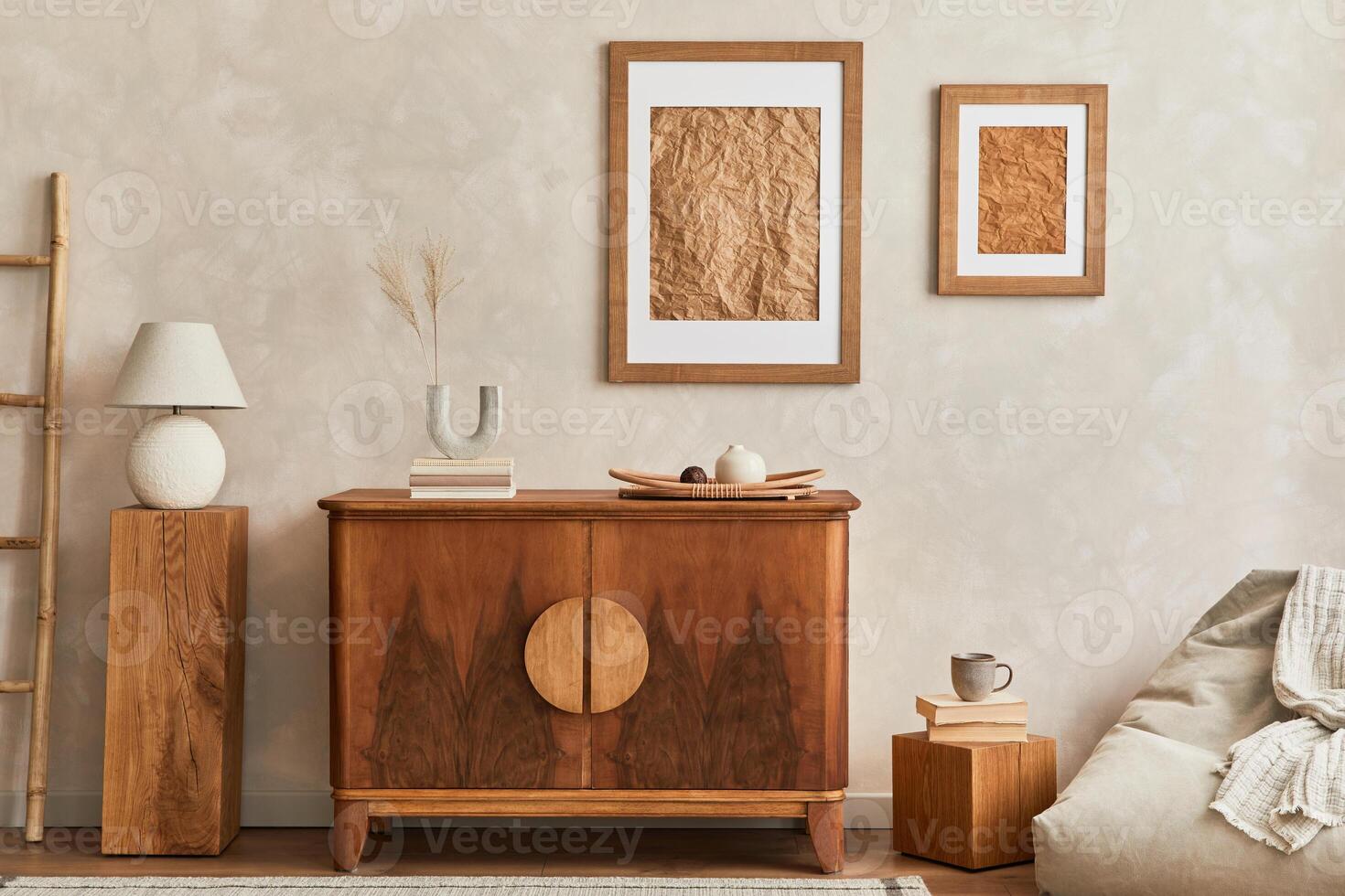 Interior design of neutral living room with stylish retro commode, cube, table lamp, decoration and elegant personal accessories in home decor. Template. Japandi concept. photo