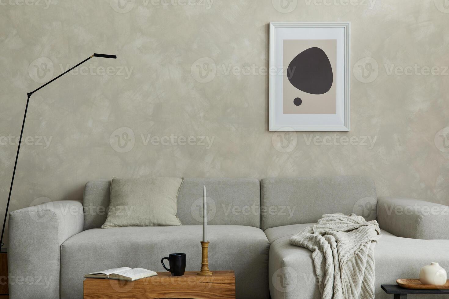 Composition of stylish japandi living room with mock up poster frame, grey sofa, wooden cubes and small personal accesories. Creative wall and parquet floor. Details. Template. photo