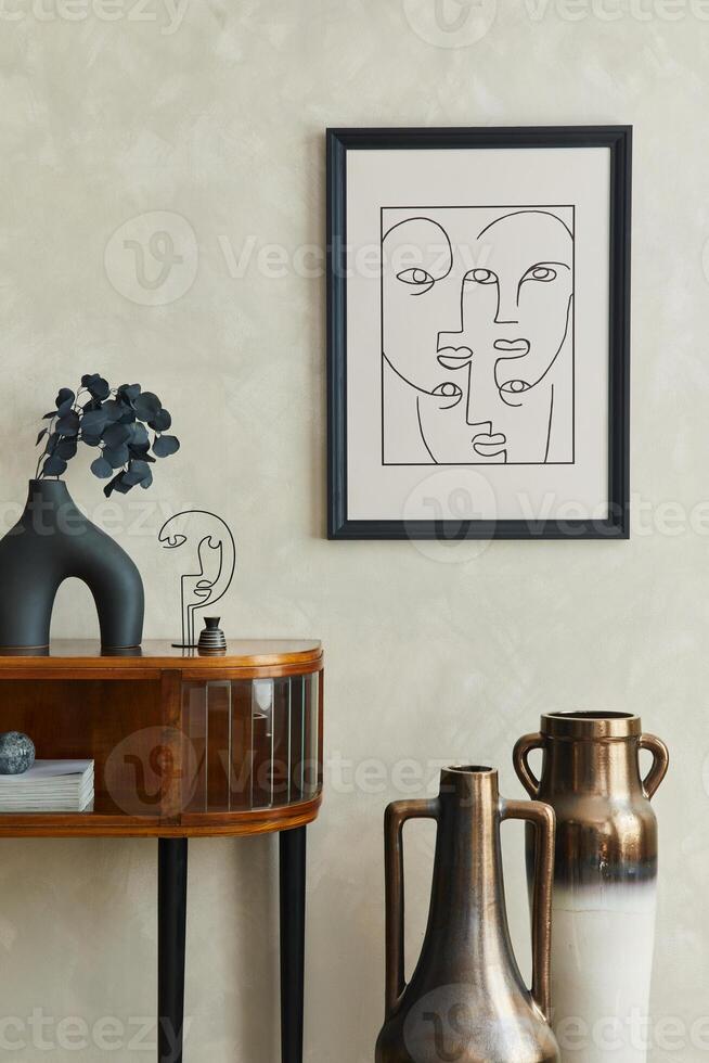 Stylish composition of creative living room interior with mock up poster frame, wooden commode, dry black leaves in black vase, two creative designed vases and elegant personal accessories. Template. photo