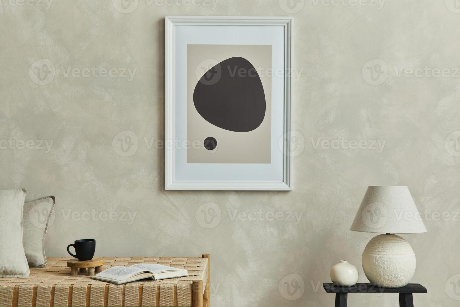 Stylish minimalistic composition of cozy living room interior with mock up poster frame, chaise longue, white lamp, coffee table and elegant personal accessories. Neutral beige wall. Template. photo