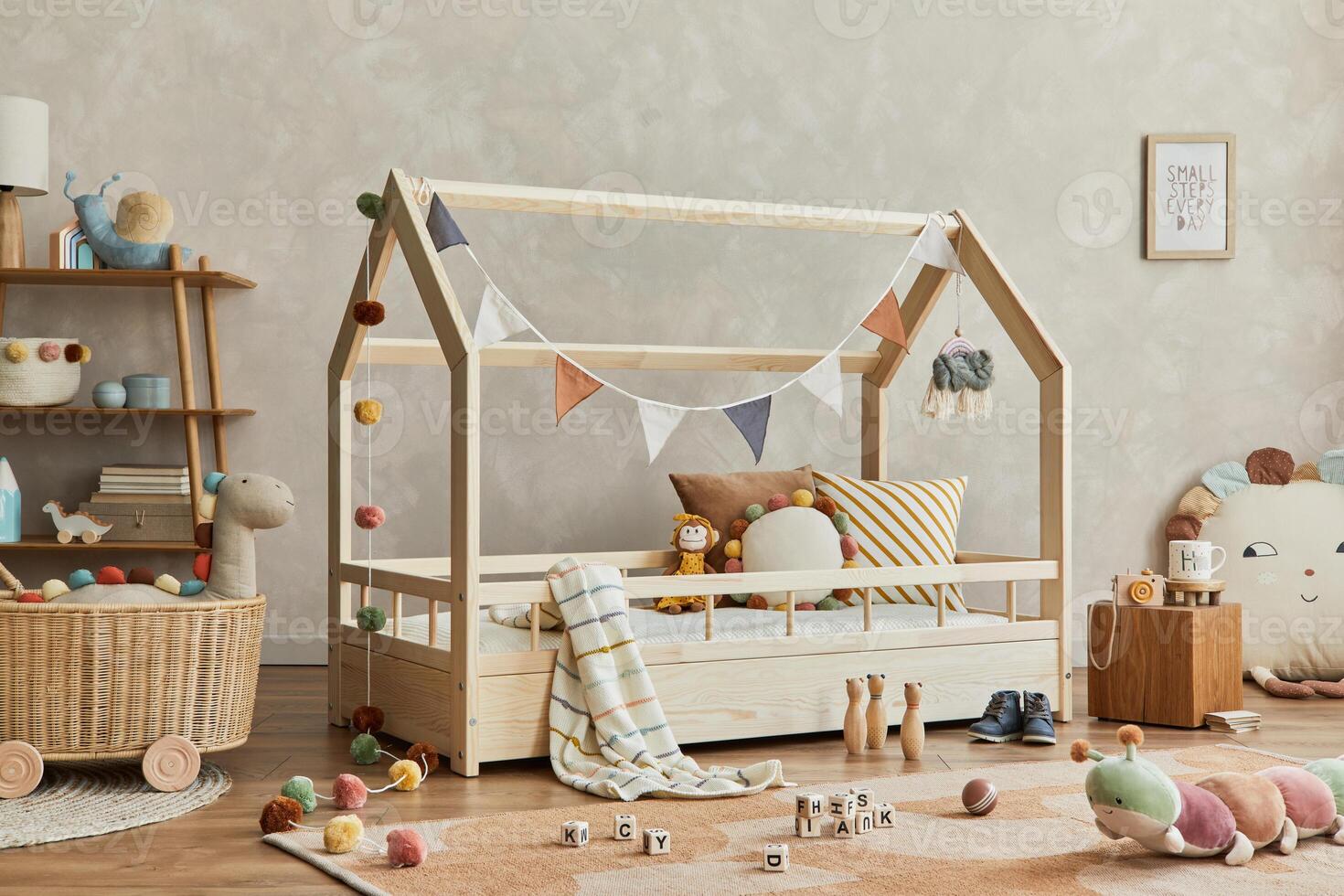 Creative composition of cozy scandinavian child's room interior with wooden bed, plush and wooden toys and textile hanging decorations. Neutral creative wall, carpet on the parquet floor. Template. photo