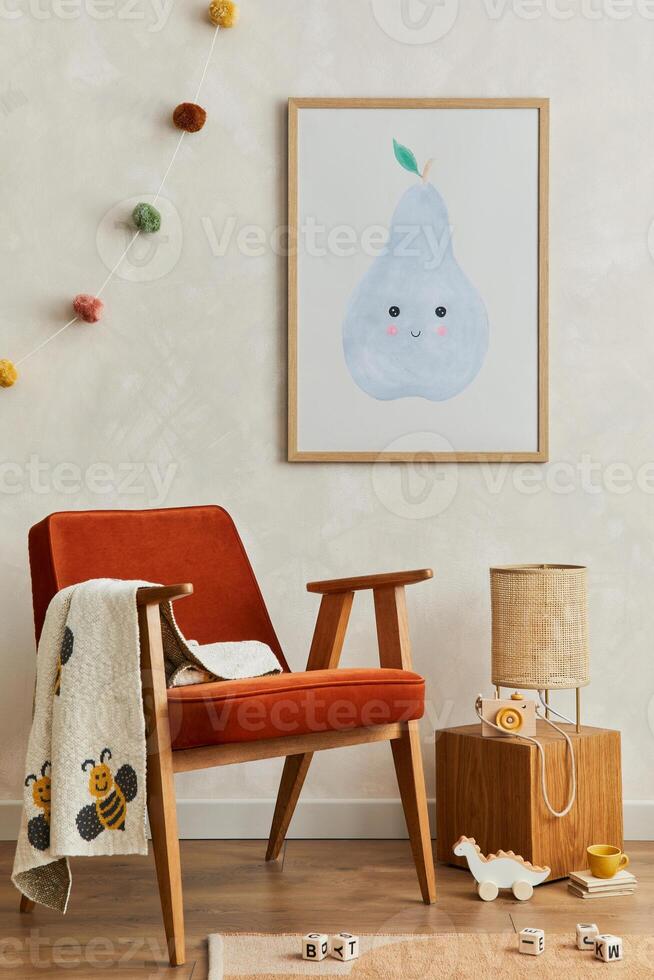 Stylish composition of cozy scandinavian child's room interior with mock up poster frame, red armchair, rattan lamp, plush toys and hanging decorations. Creative wall, carpet on the floor. Template. photo