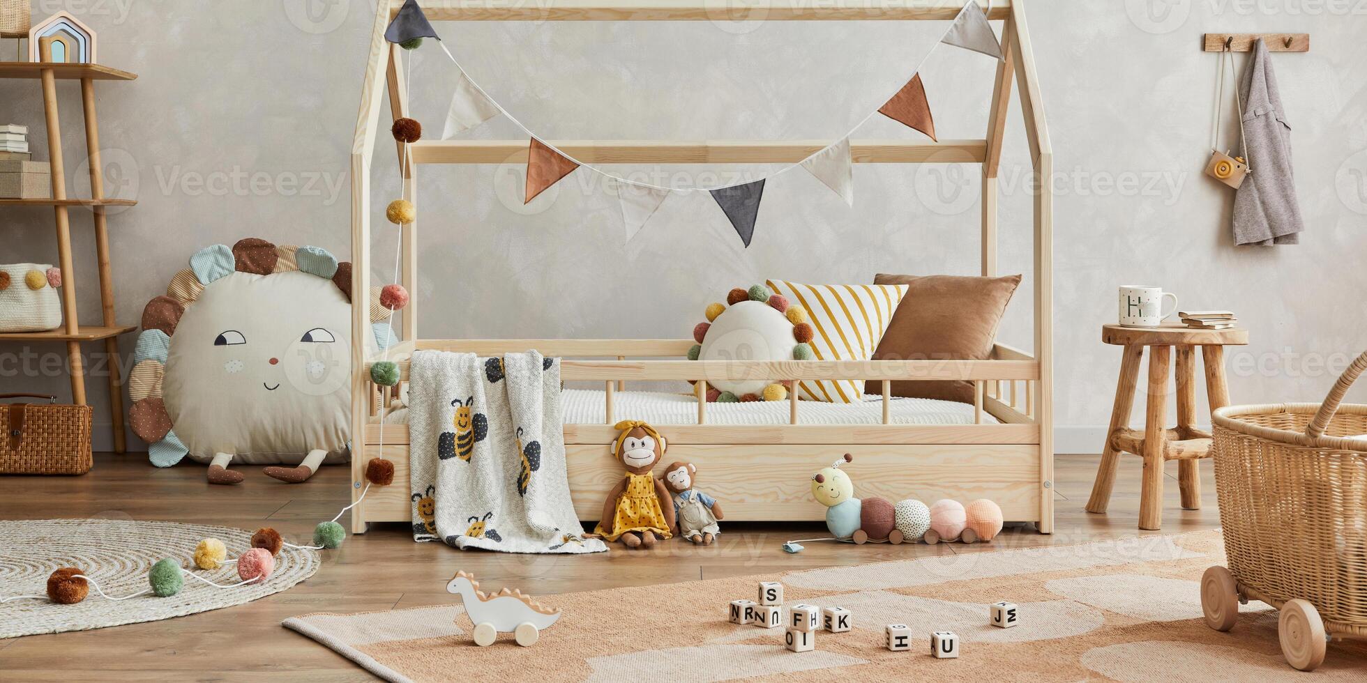 Stylish composition of cozy scandinavian child's room interior with wooden bed and coffee table, plush and wooden toys and textile hanging decorations. Creative wall, carpet on the floor. Template. photo