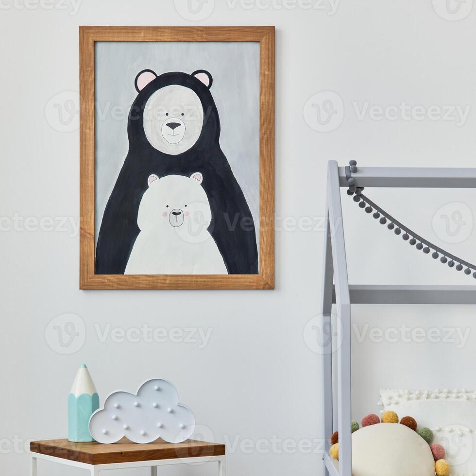 Stylish scandinavian child's room interior with mock up poster frame, creative bed, wooden cube, plush and wooden toys and hanging textile decorations. Grey wall, carpet on the floor. Template. photo