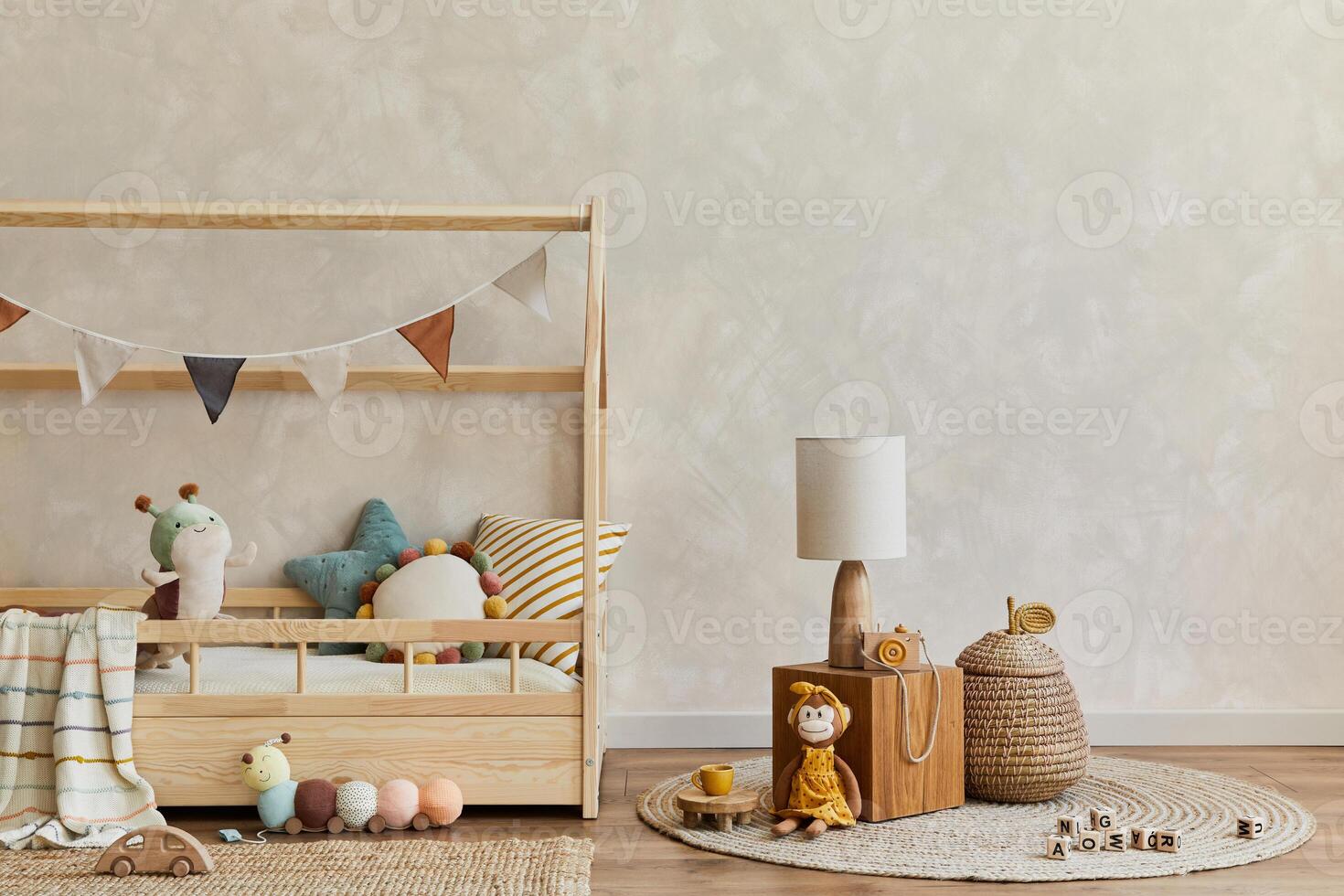 Stylish composition of cozy scandinavian child's room interior with bed, wooden cube, plush and wooden toys and textile hanging decorations. Creative wall, carpet on the floor. Copy space. Template. photo