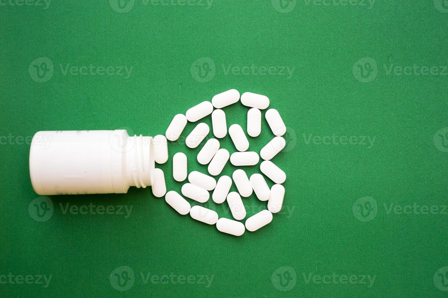 Pills , tablets, pill bottle isolated on green. copy space. Medicine pharmacy pharmacology health concept photo