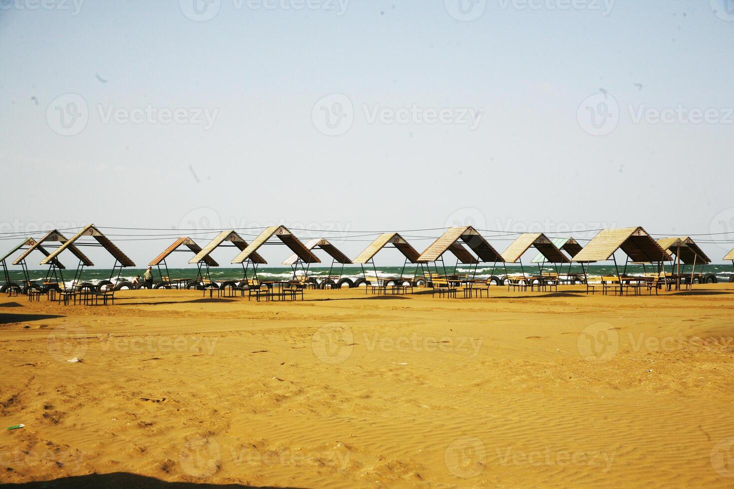 Sun umbrella on beautiful beach with turquoise water. photo