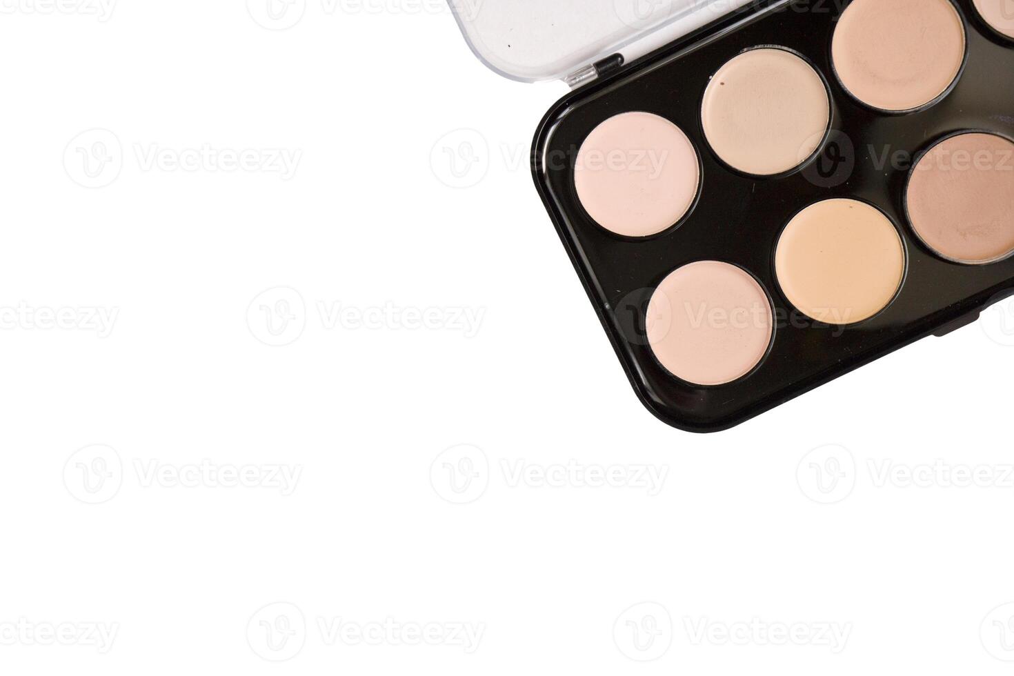 Powder brown color in black powder case which opened and powder puff with ribbon isolated on white background. photo