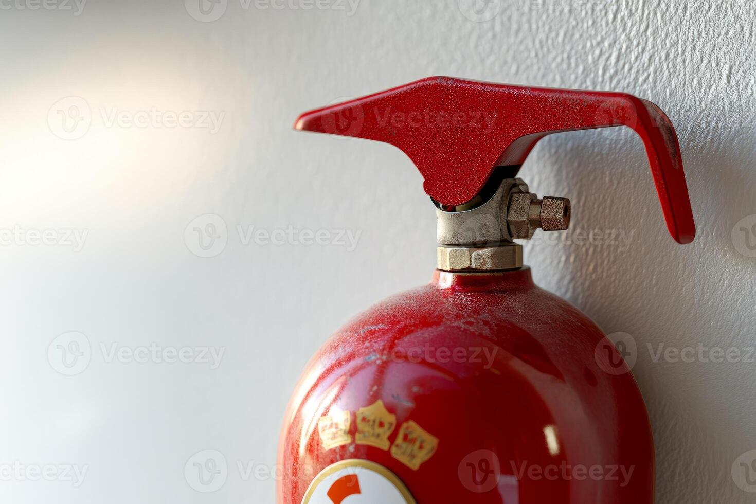 fire extinguisher on white wall, close up photo