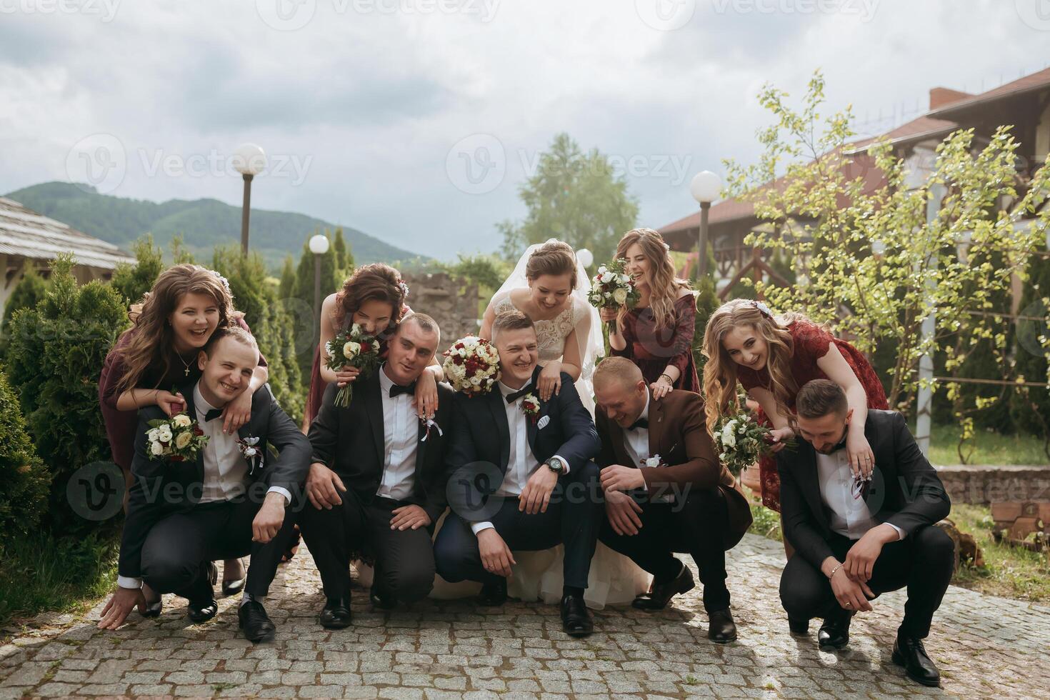 A group of people, including a bride and groom, are posing for a picture photo