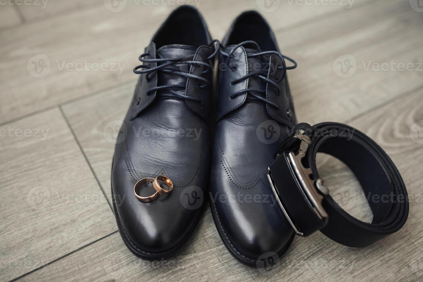 A pair of shoes with a ring on each toe and a belt on the right side photo