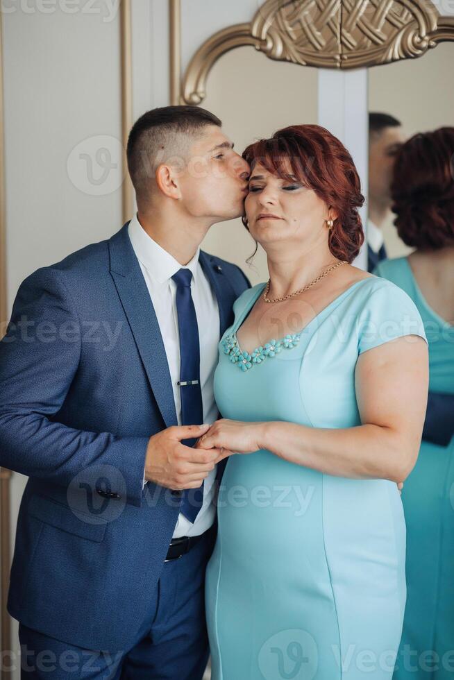 A man kisses a woman's cheek photo