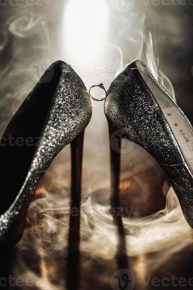 Two women's shoes with a ring on the left one photo