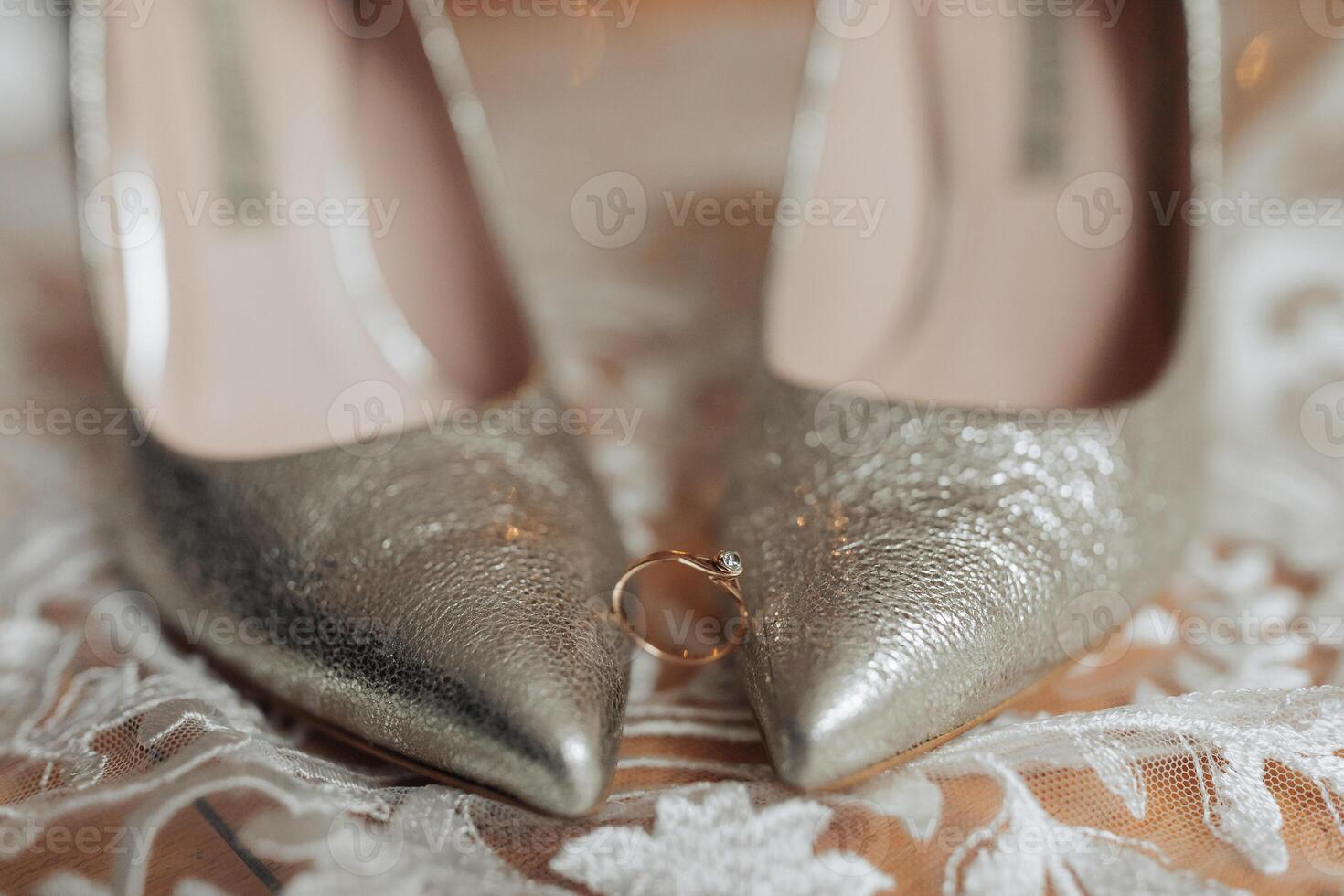 A pair of high heels with a ring on the toe photo