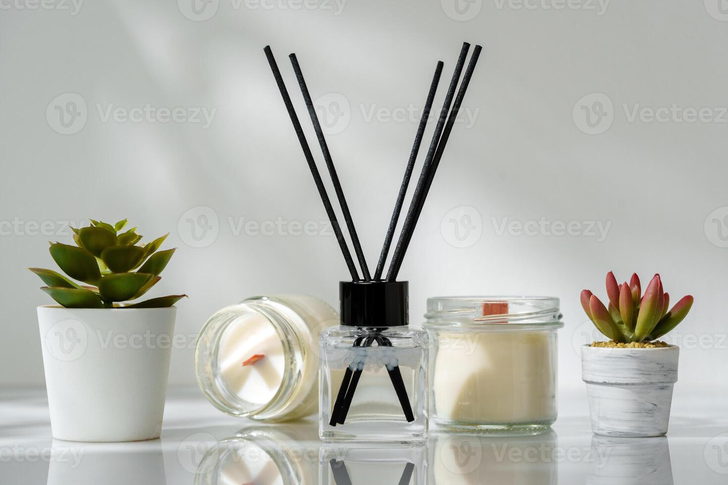 Elegant Home Fragrance Reed Diffuser Displayed Beside Scented Candles and Succulents photo