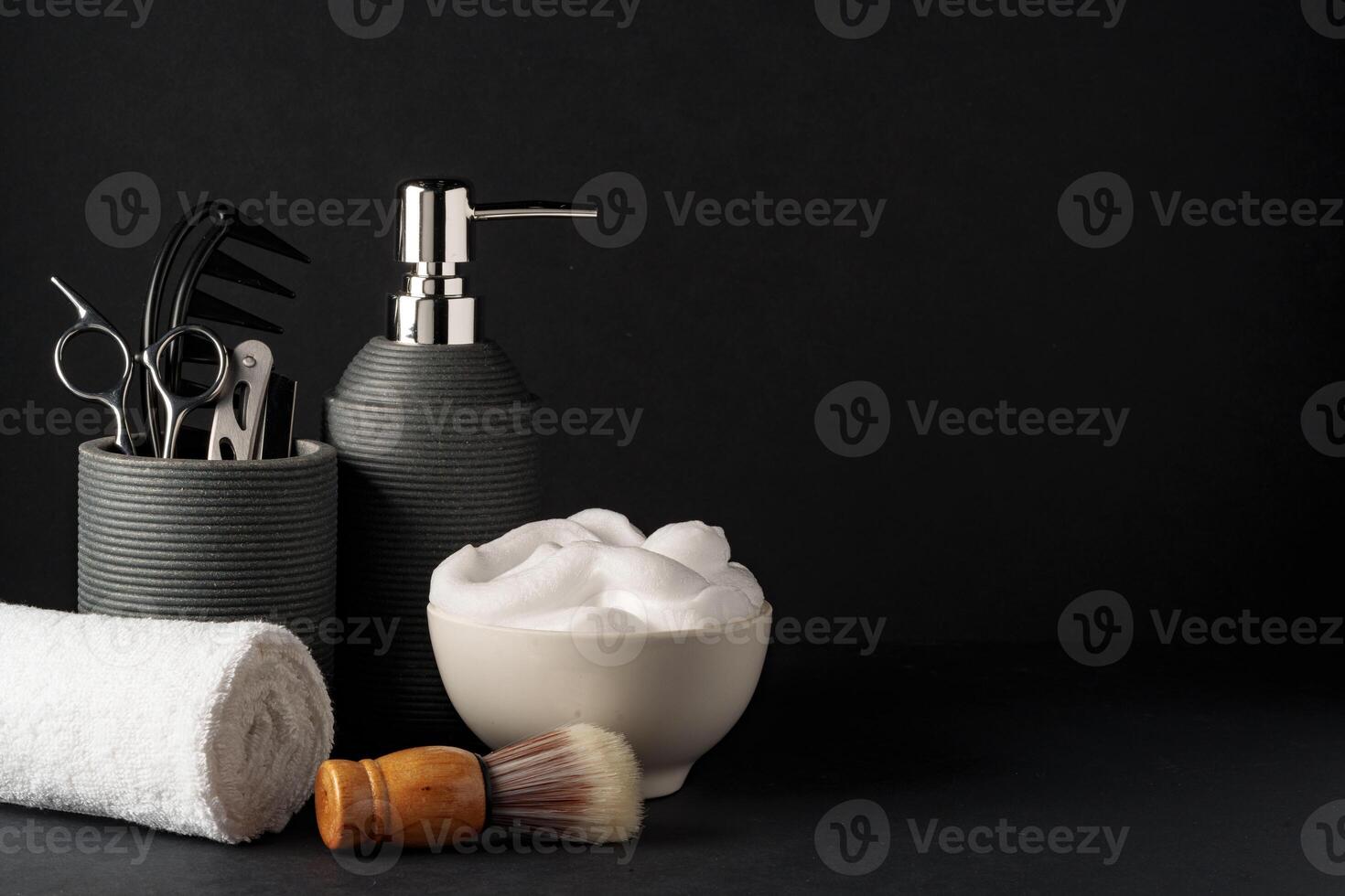 Professional Barber Tools Displayed on Black Background With Towel and Shaving Cream photo