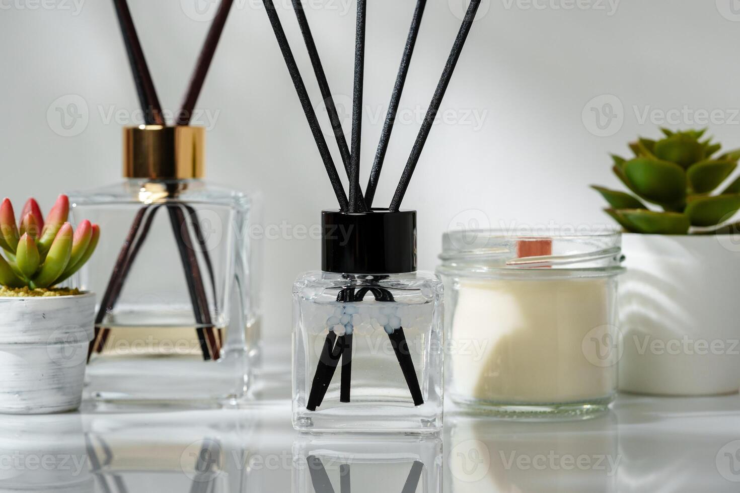 Elegant Home Fragrance Reed Diffuser Displayed Beside Scented Candles and Succulents photo