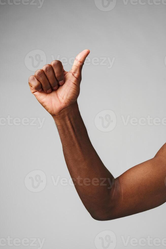 Man in White Shirt Pointing at Something on gray background photo