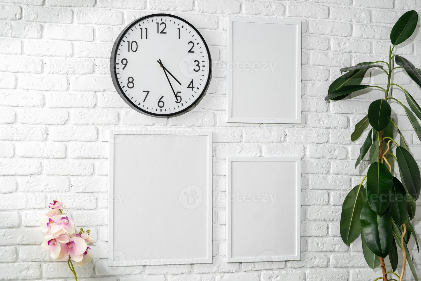 Minimalist White Wall Display With Clock and Empty Frames in a Modern Interior photo