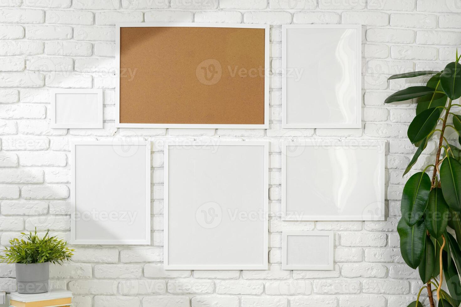 Varied Sized Photo Frames Displayed on a White Brick Wall