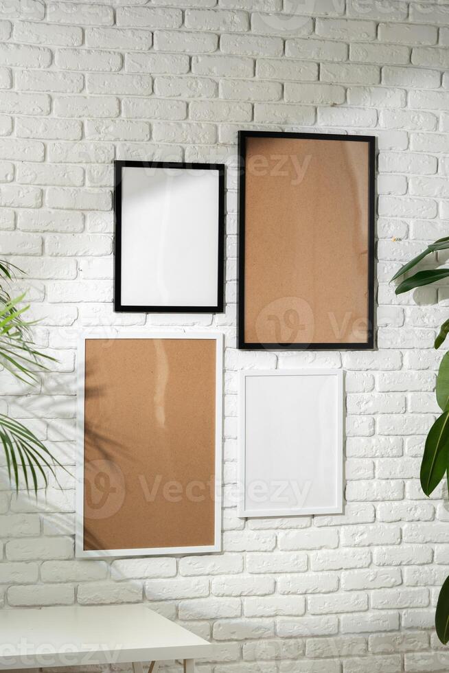 Varied Sized Photo Frames Displayed on a White Brick Wall