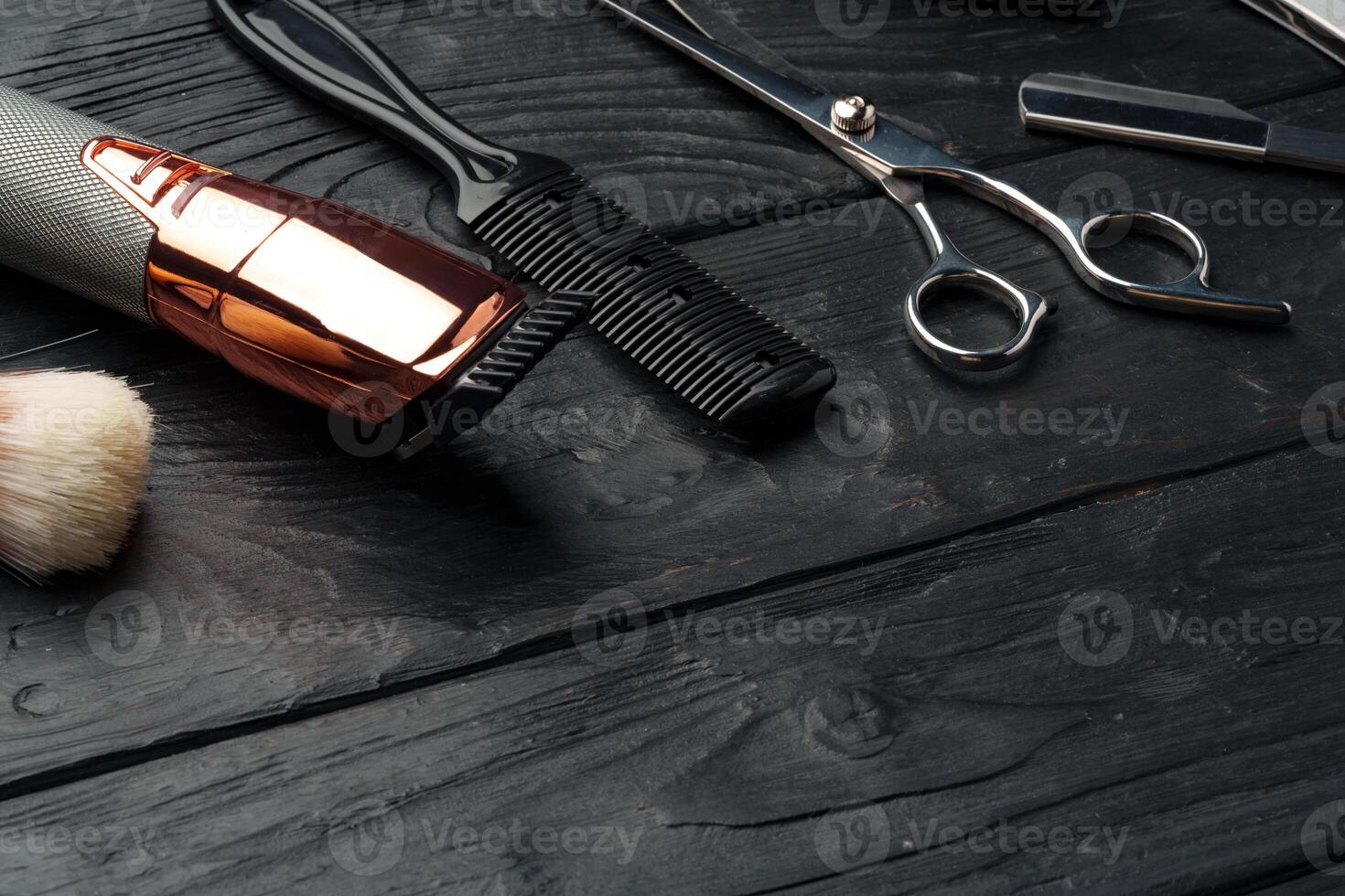 Professional Barber Tools Laid Out on Dark Wooden Surface photo