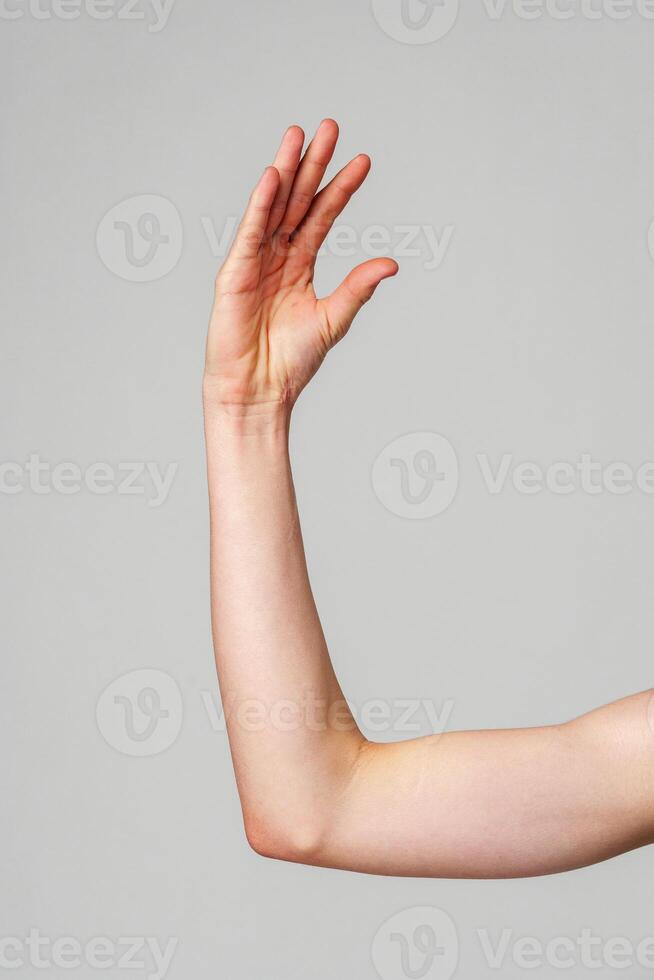 Close-Up of a Human Arm Extended Against a Plain Background photo