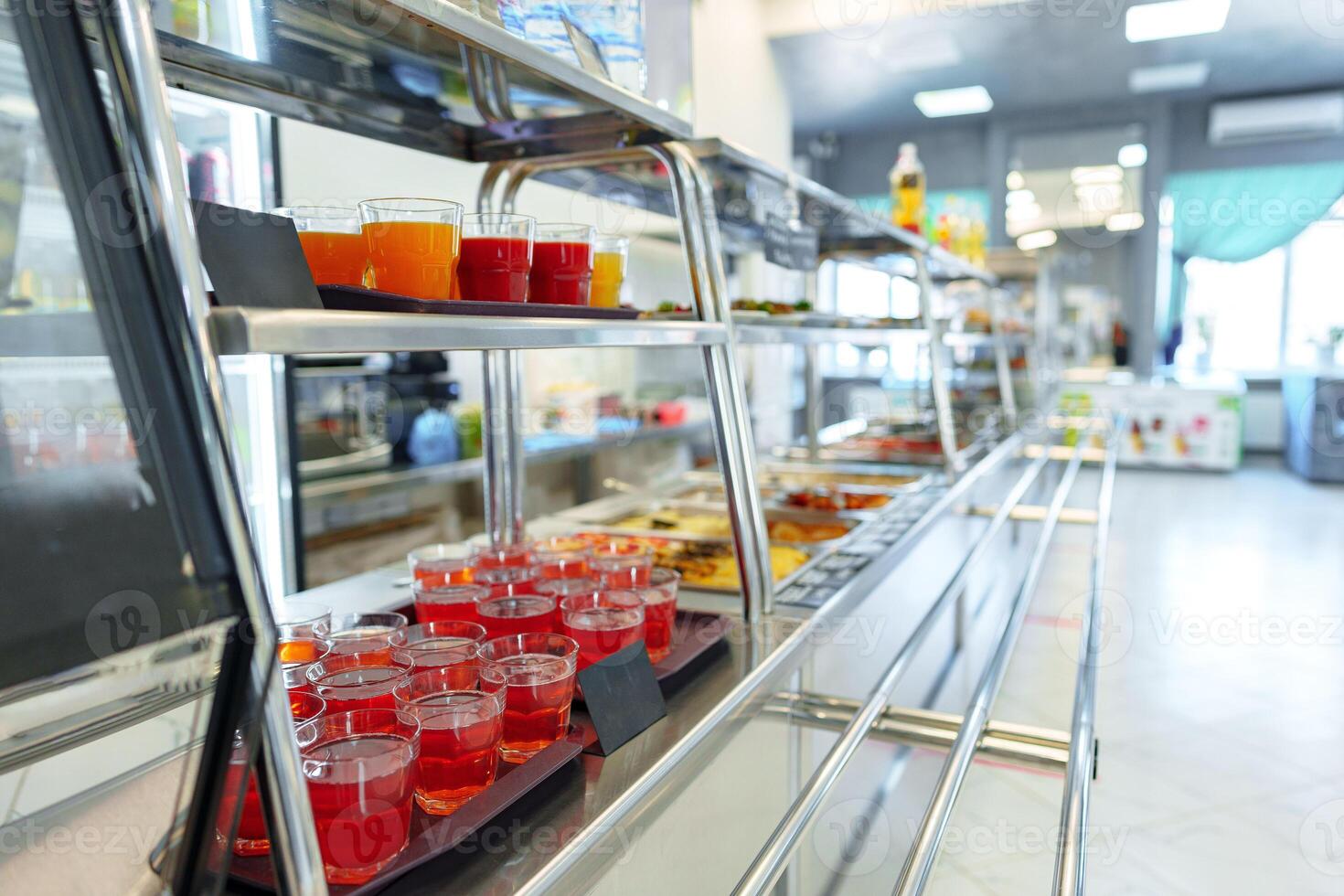 Colorful Array of Fruit Juice Cups on a Serving Cart in a Cafeteria photo