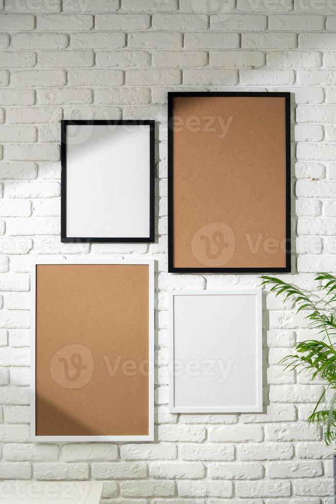 Varied Sized Photo Frames Displayed on a White Brick Wall