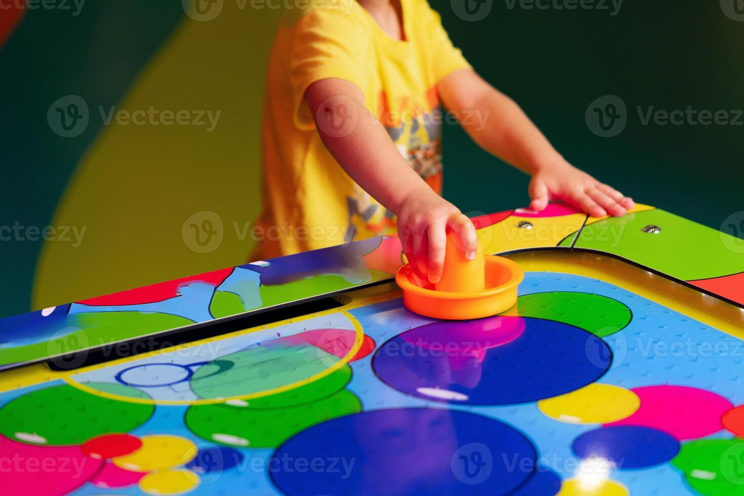 Young Child Playing Twister Game With Colorful Spinner on Bright Mat photo