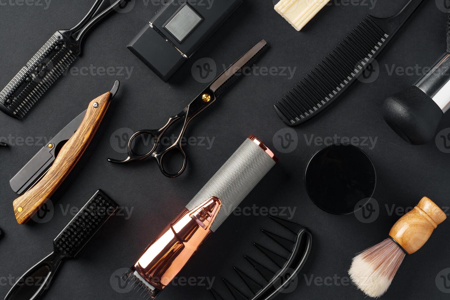An Assortment of Professional Hairdressing Tools Laid Out on a Dark Surface photo