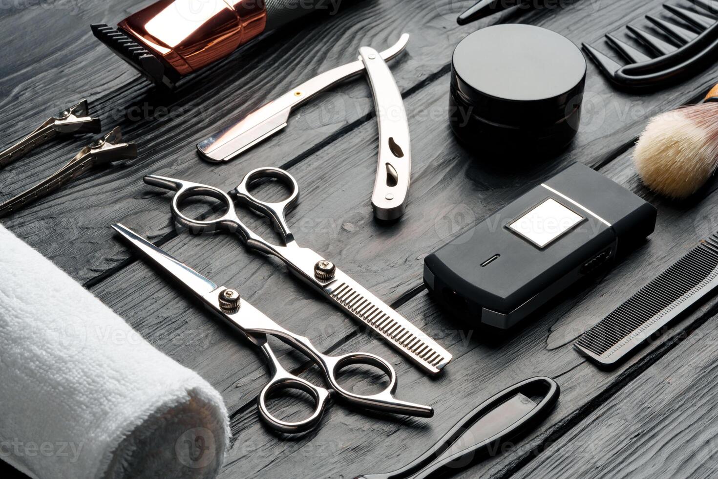 Professional Barber Tools Laid Out on Dark Wooden Surface photo