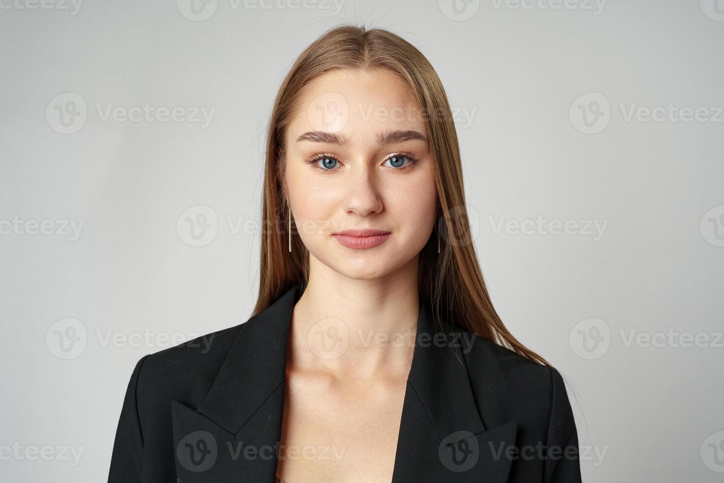 Young Woman in Black Jacket Posing to Camera against gray background photo