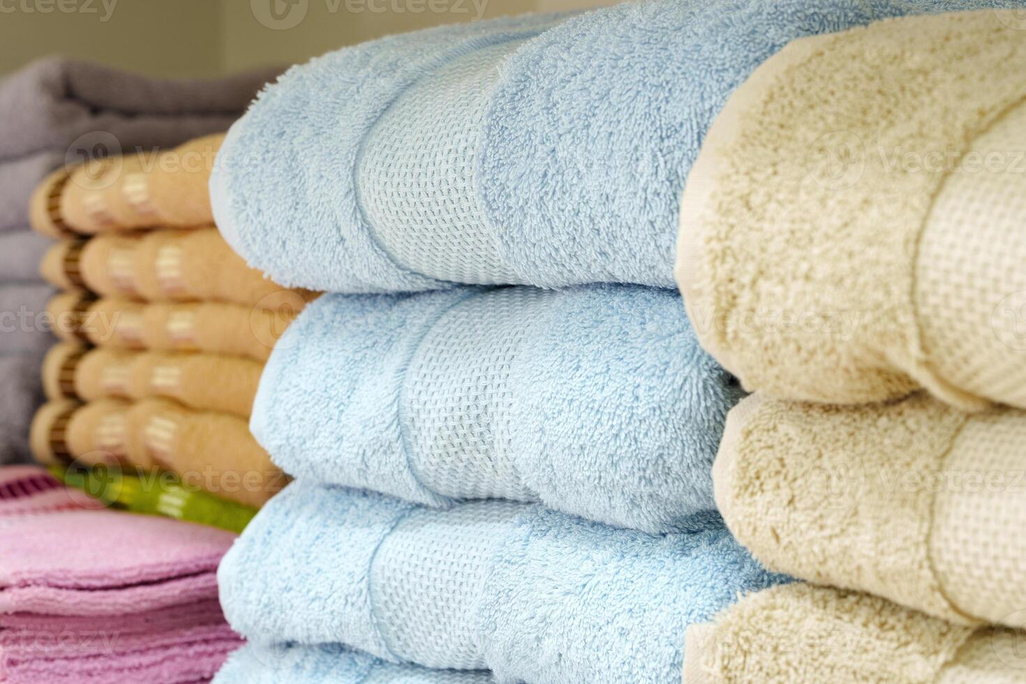 Stack of Neatly Folded White Towels on a Retail Store Shelf photo