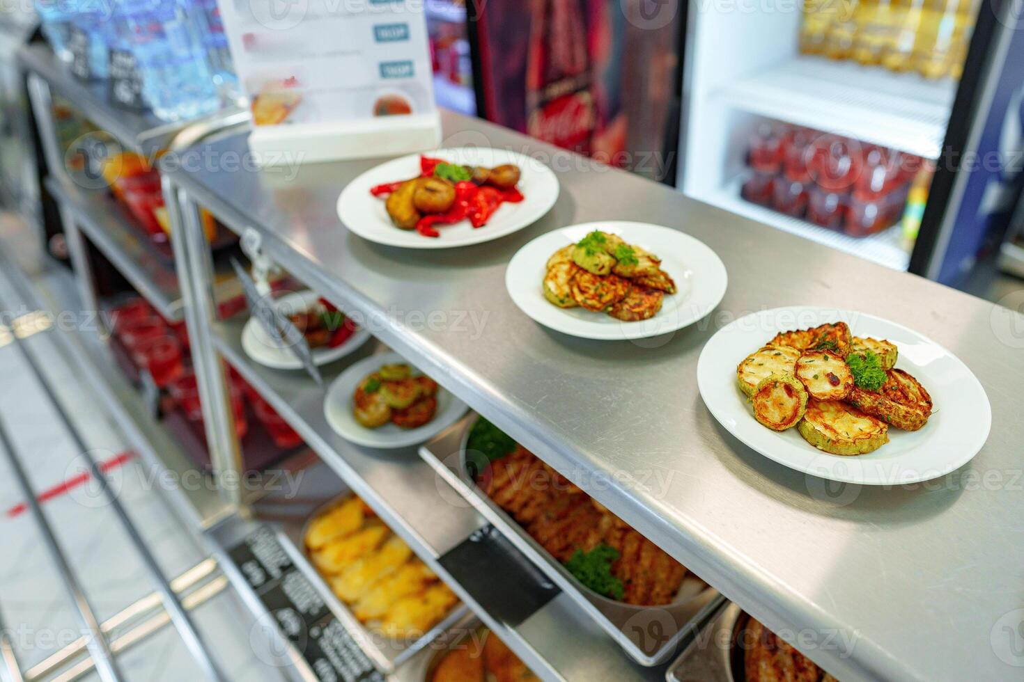 Assorted Gourmet Dishes Displayed on Shelves in a Modern Deli photo