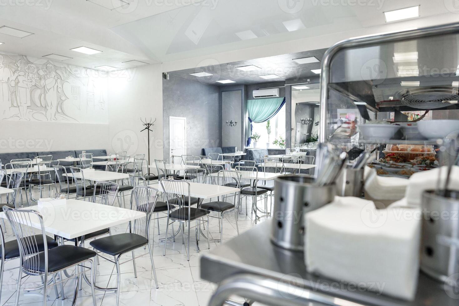 Modern Cafeteria Interior With Sleek Metal Chairs and Tables During Daytime photo