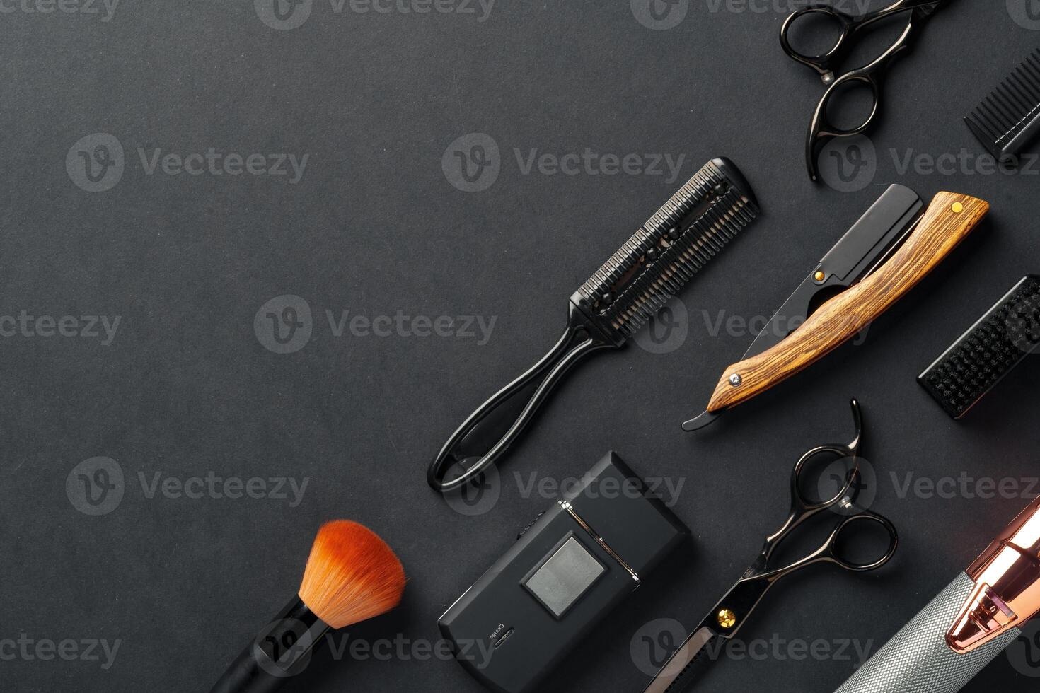 An Assortment of Professional Hairdressing Tools Laid Out on a Dark Surface photo