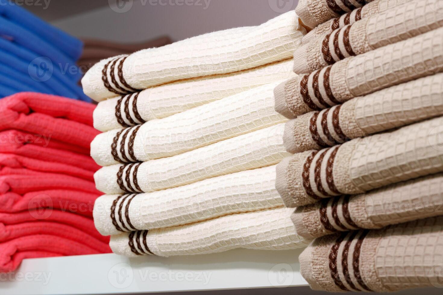 Stack of Neatly Folded White Towels on a Retail Store Shelf photo