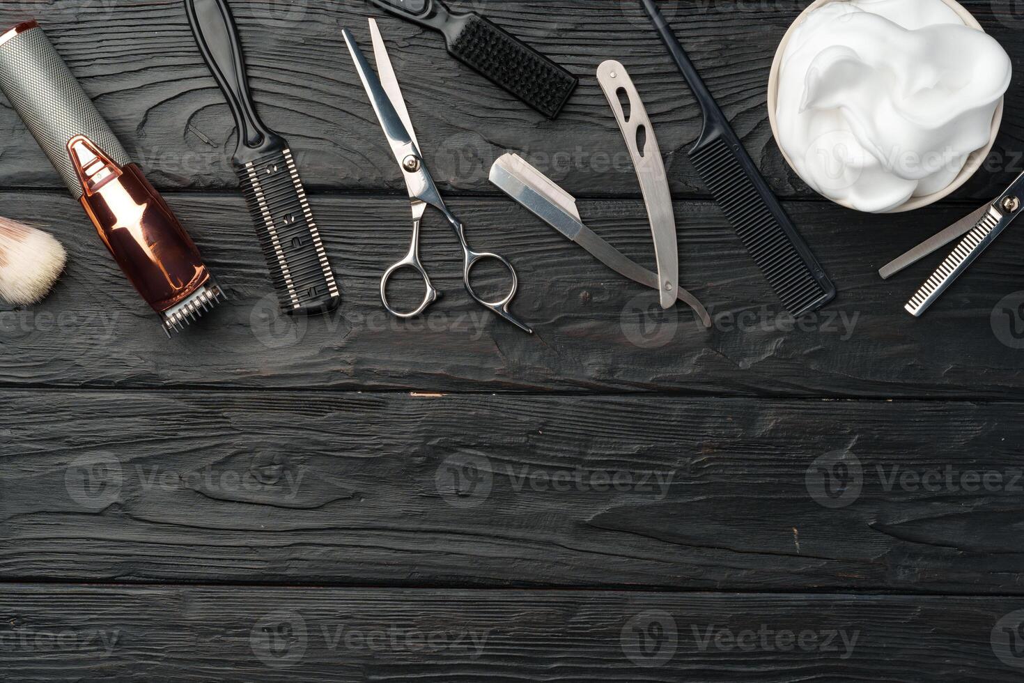 Professional Barber Tools Laid Out on Dark Wooden Surface photo