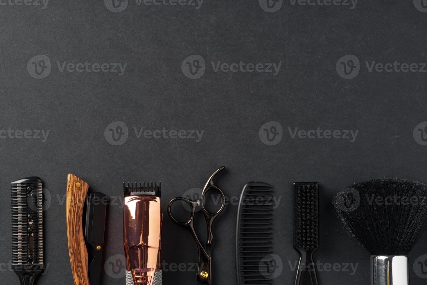 An Assortment of Professional Hairdressing Tools Laid Out on a Dark Surface photo