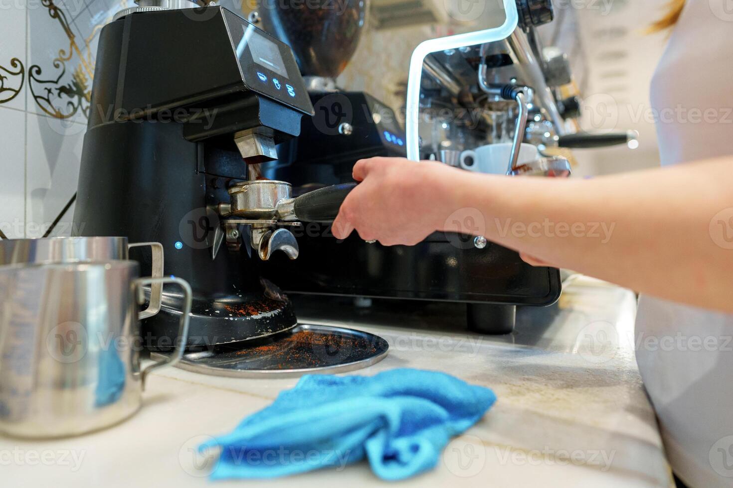 Barista Operating Espresso Machine at a Busy Coffee Shop During Morning Rush photo