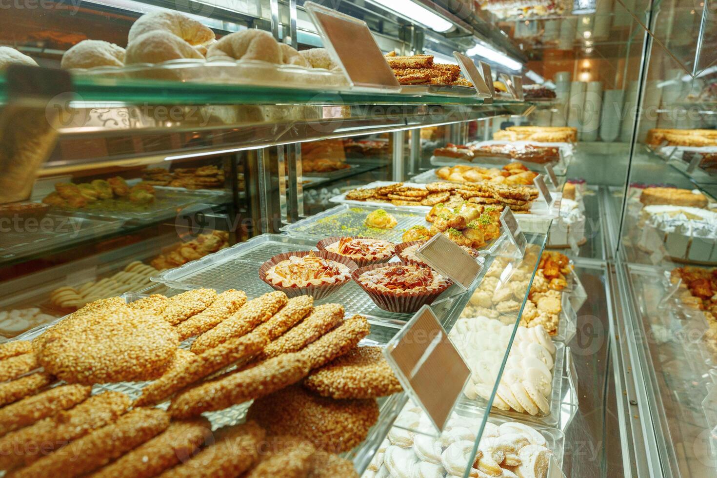 Delectable Assortment of Pastries and Sweets on Display at a Bakery Shop photo