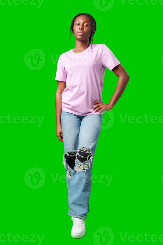 Young woman with curly hair shows a skeptical expression against a bright green background photo
