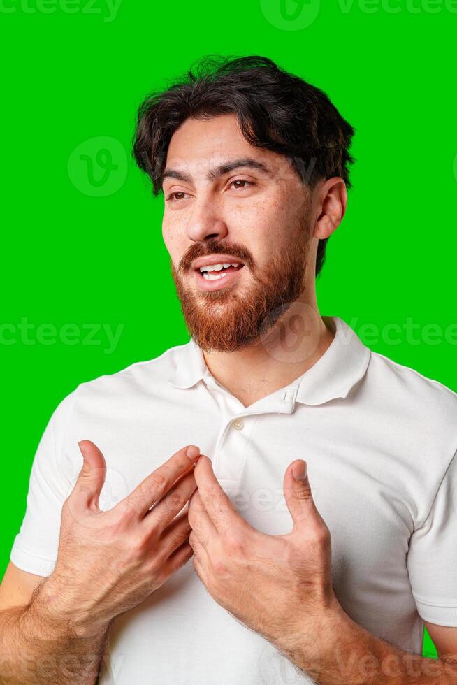 Smiling man in a white polo shirt standing confidently against a bright green background photo